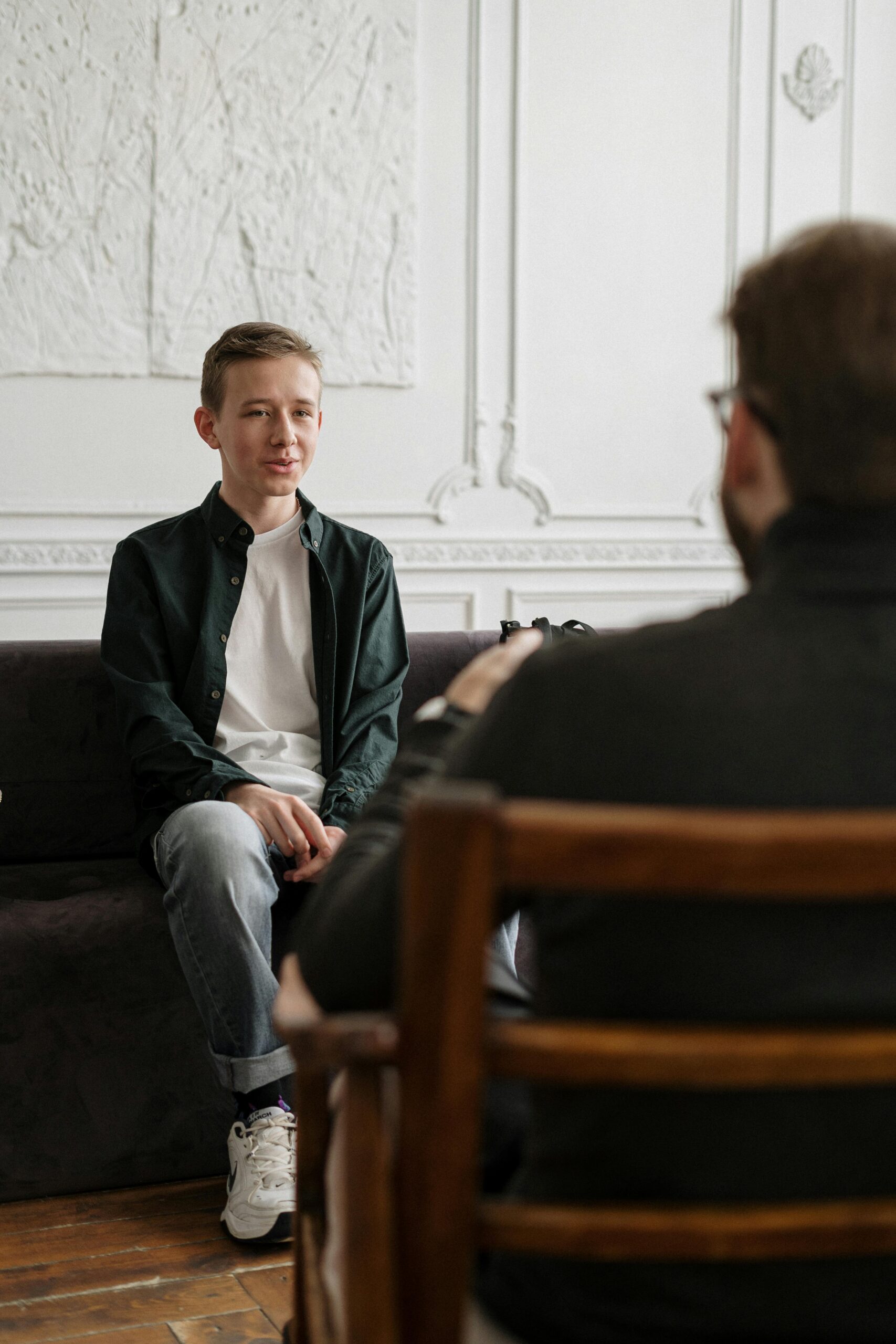 Photo by cottonbro studio: https://www.pexels.com/photo/man-in-black-sweater-sitting-on-brown-wooden-chair-4100669/